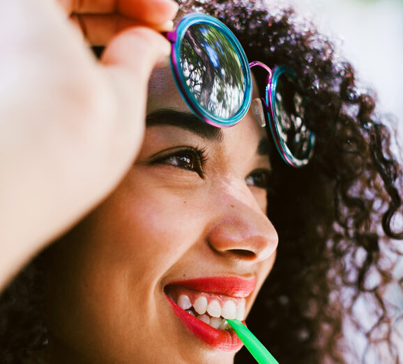 Young Latin Afro Woman Drinking A Smoothie On The Street.